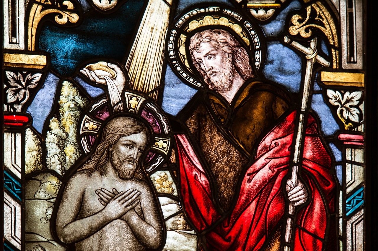 Stained glass window depicting the baptism of Jesus, symbolising faith and history at St. Clement’s Church, Eurobin